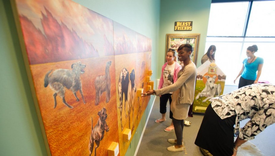 Students examine artwork in gallery