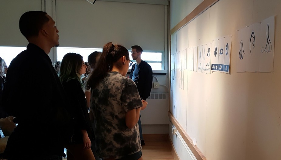 Students reviewing work during a critique