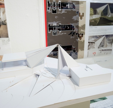 An Interior Design model in front of drafting plans